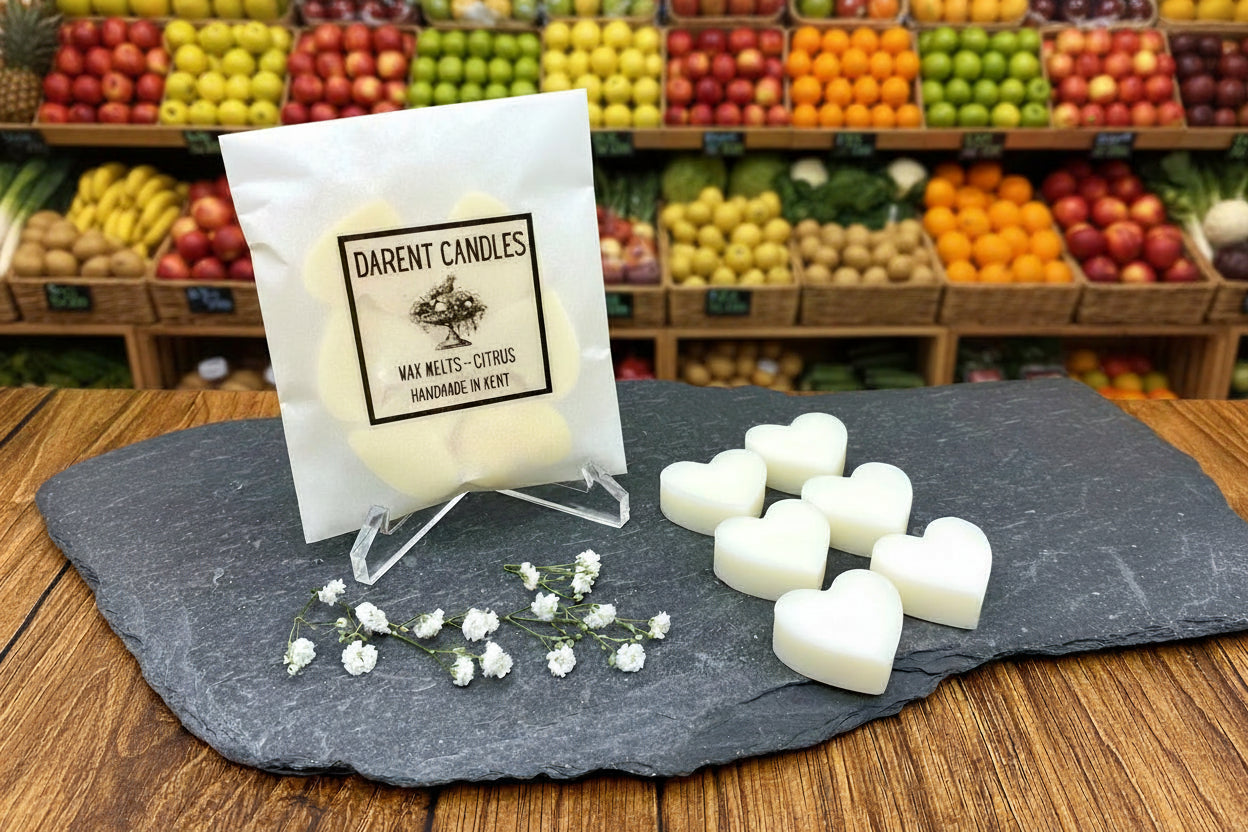 Darent Candles packaging with wax melts on a slate surface in a grocery store setting